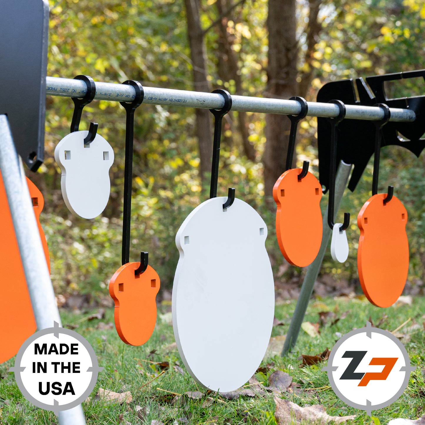 Various sized orange and white gong targets hanging on black hooks