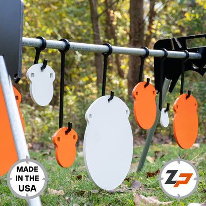 Various sized orange and white gong targets hanging on black hooks